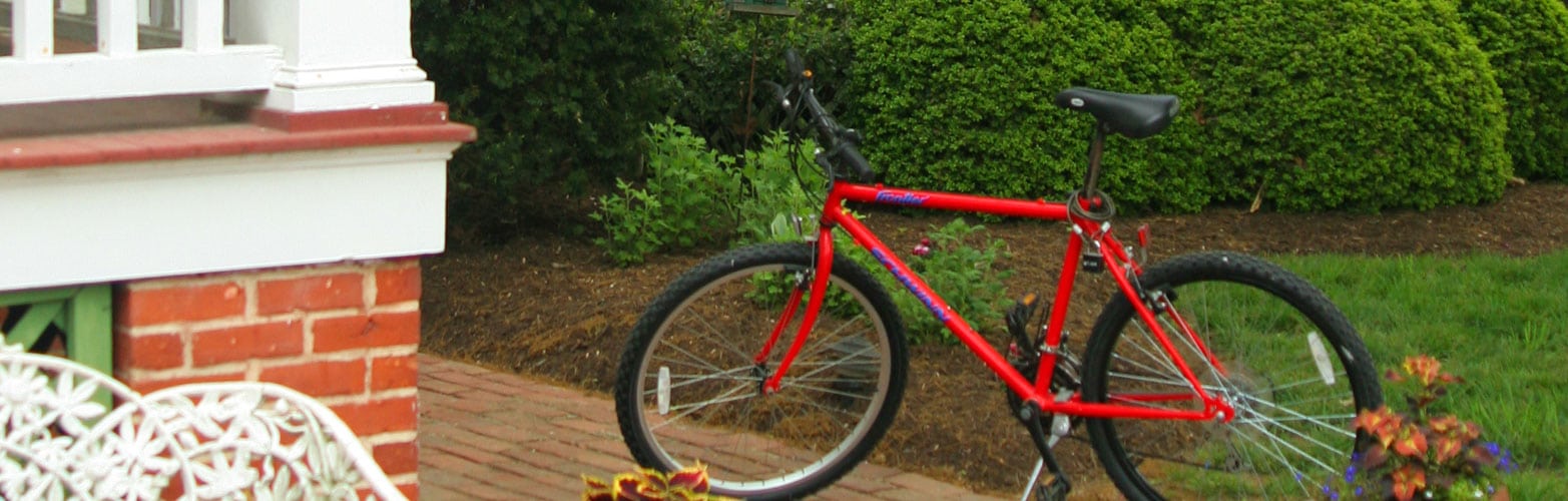A red bicycle near the rear porch of the Bishops House